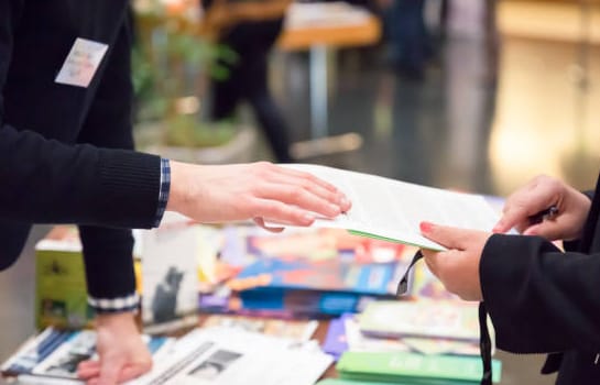 Sharing pamphlets at tradeshow